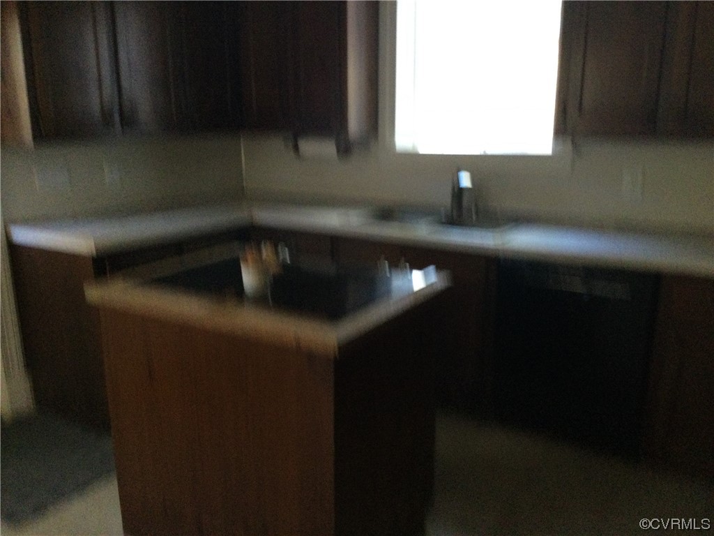 236 Buford Road Richmond, VA 23235 - Photo 32 of 42 a kitchen with a sink wooden cabinets and a fireplace