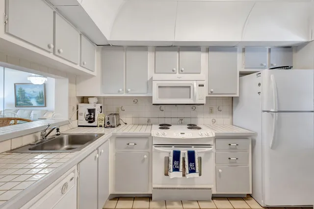 a kitchen with a sink stove and refrigerator