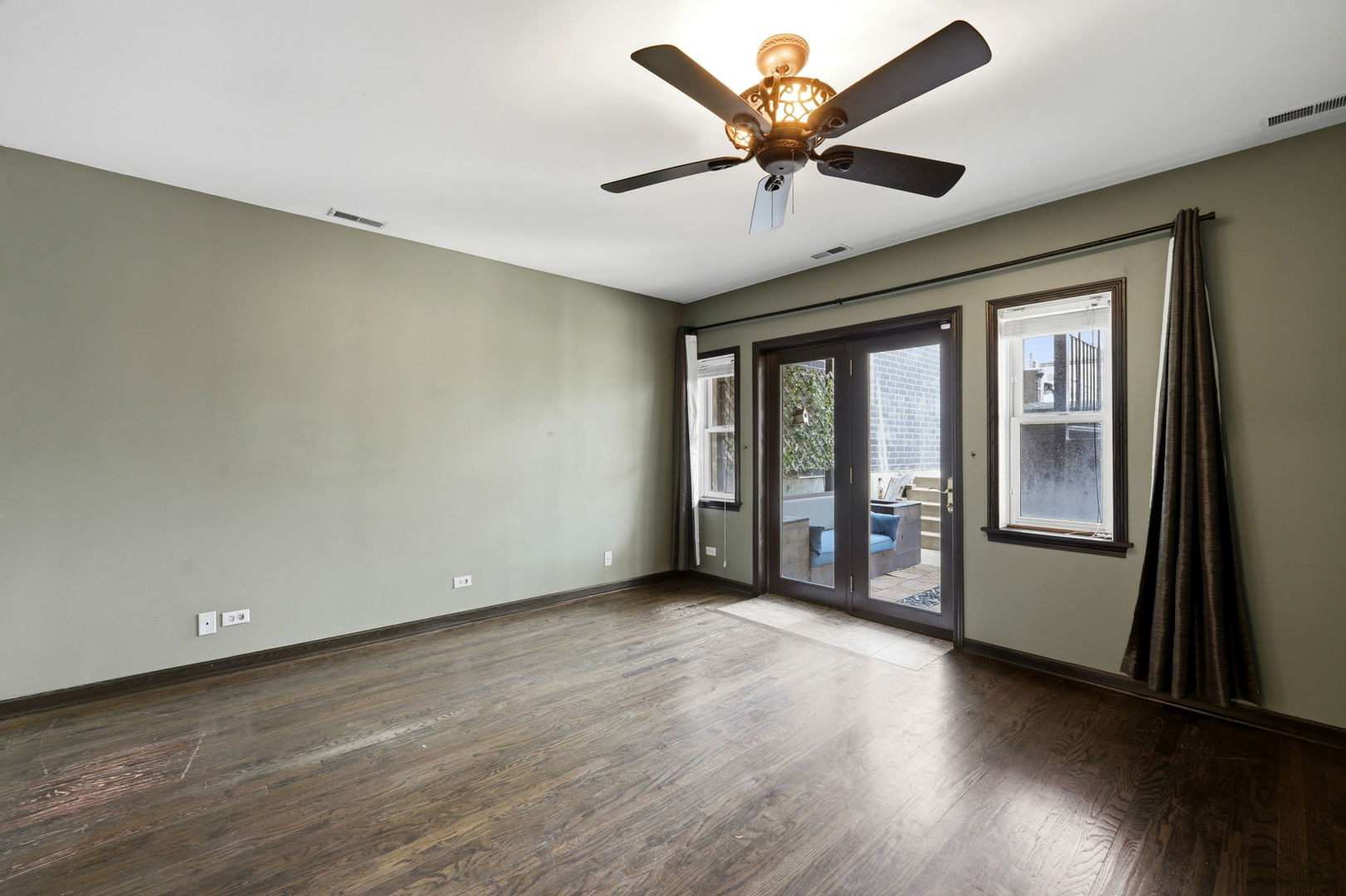 619 North Racine Avenue, Unit 1 Chicago, IL 60642 - Photo 19 of 36 an empty room with wooden floor and windows