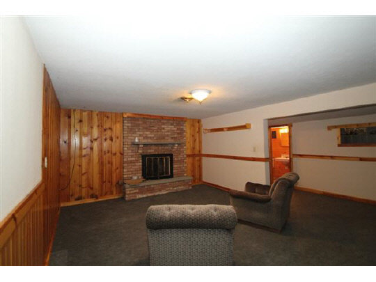 1813 Warren Road Rockford, IL 61108 - Photo 10 of 11 a living room with furniture and a fireplace