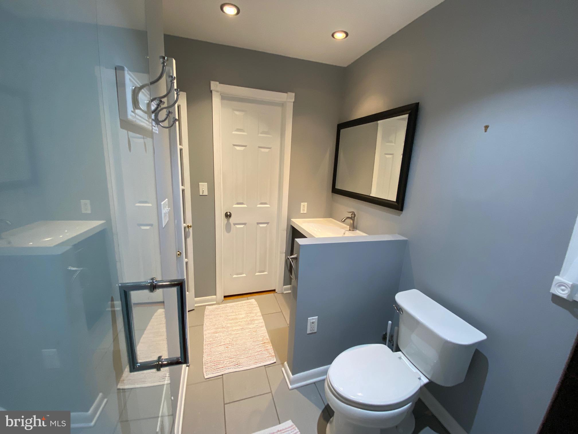 15918 Jerald Road Laurel, MD 20707 - Photo 19 of 40 a bathroom with a toilet a sink and mirror