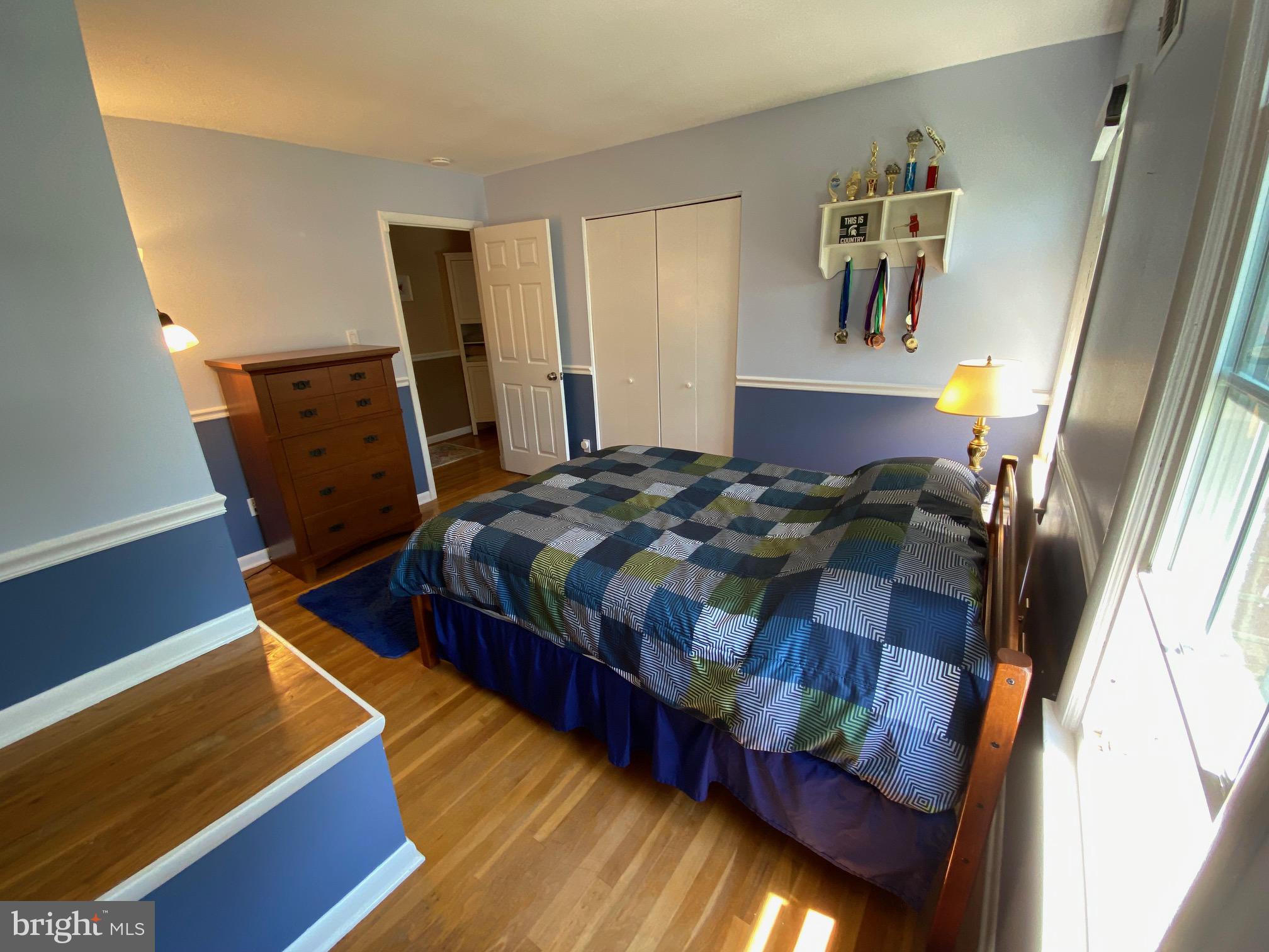 15918 Jerald Road Laurel, MD 20707 - Photo 23 of 40 a bedroom with a bed and wooden floor