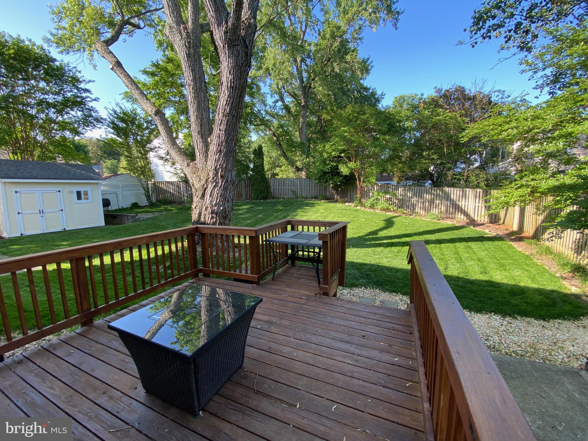 15918 Jerald Road Laurel, MD 20707 - Photo 36 of 40 a view of a deck with chairs a barbeque with wooden floor and fence