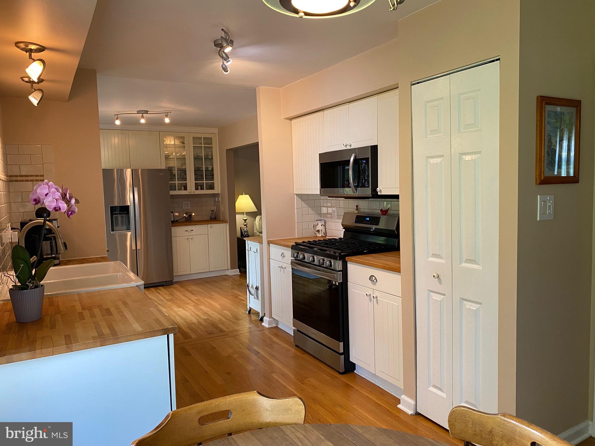 15918 Jerald Road Laurel, MD 20707 - Photo 4 of 40 a kitchen with a refrigerator and a stove top oven