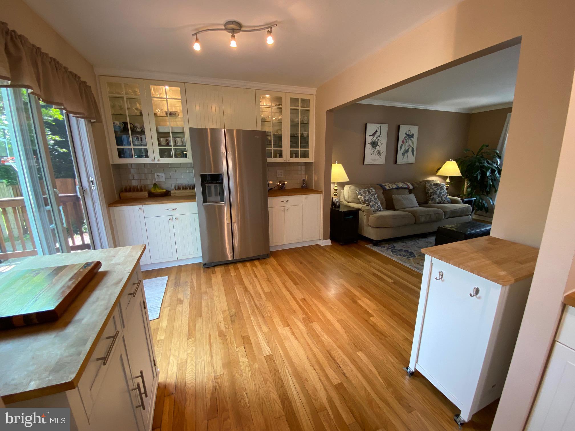 15918 Jerald Road Laurel, MD 20707 - Photo 9 of 40 a living room with stainless steel appliances furniture wooden floor and a kitchen view