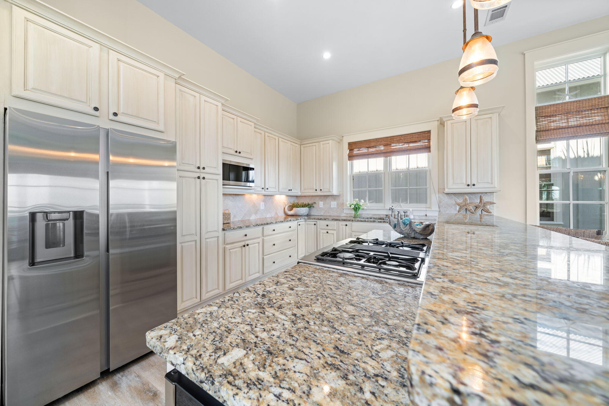 255 Cypress Drive Santa Rosa Beach, FL 32459 - Photo 31 of 81 a kitchen with stainless steel appliances granite countertop a refrigerator a stove a sink and white cabinets with wooden floor