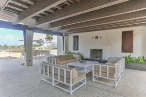 255 Cypress Drive Santa Rosa Beach, FL 32459 - Photo 70 of 81 a spacious bedroom with a bed a balcony with furniture and a fireplace