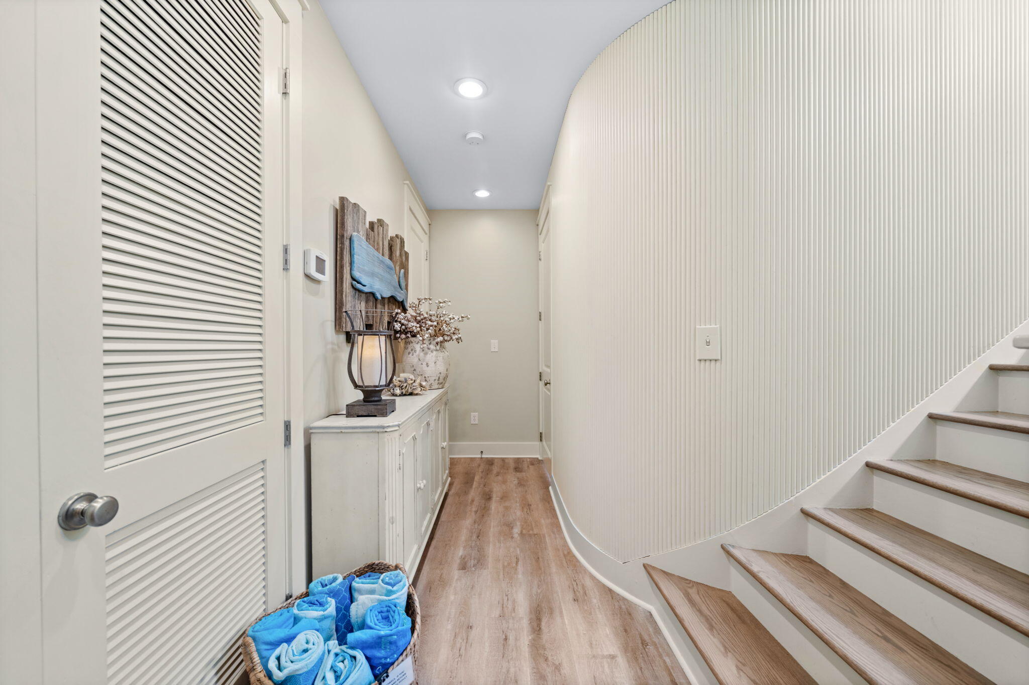 255 Cypress Drive Santa Rosa Beach, FL 32459 - Photo 8 of 81 a view of a hallway with wooden floor and staircase