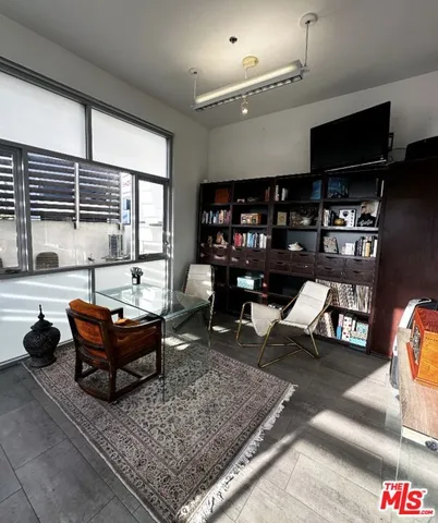 a living room with furniture a rug and a large window