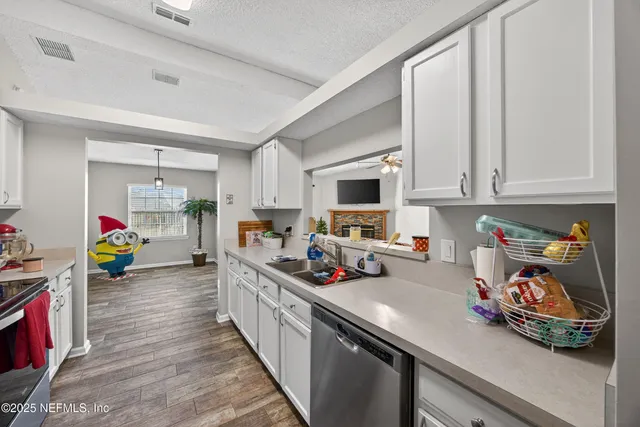 a kitchen with stove and cabinets
