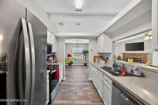 a kitchen with stainless steel appliances a refrigerator and a stove