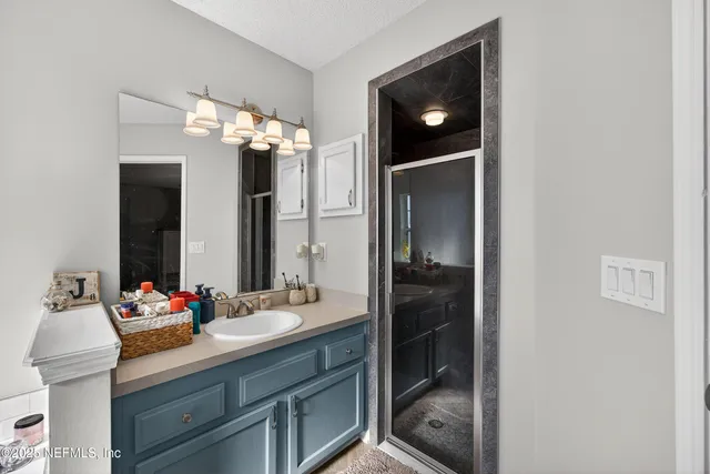 a bathroom with a sink a mirror and vanity