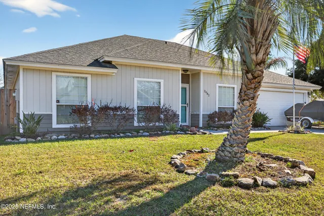 a view of a house with swimming pool and a yard