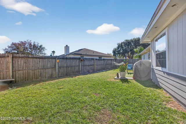 a view of a backyard with table and chairs
