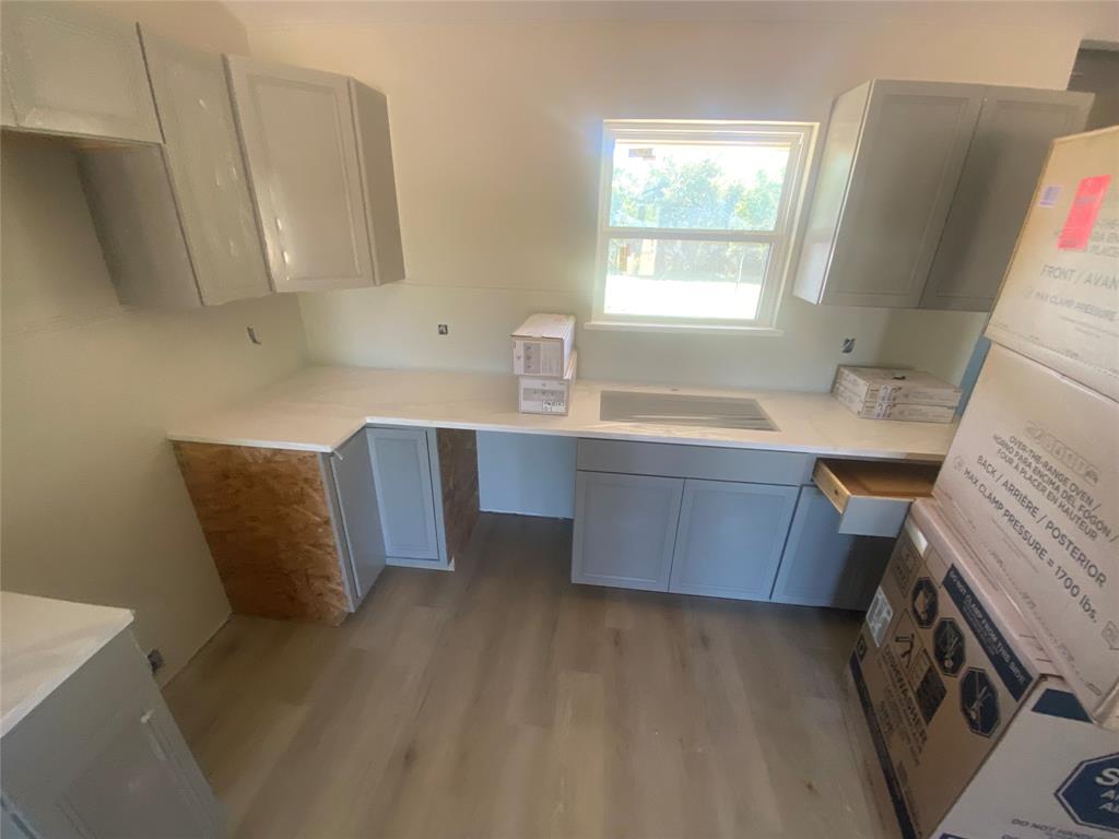 1032 Rays Way Weatherford, TX 76085 - Photo 9 of 25 a room with wooden cabinets and a chair