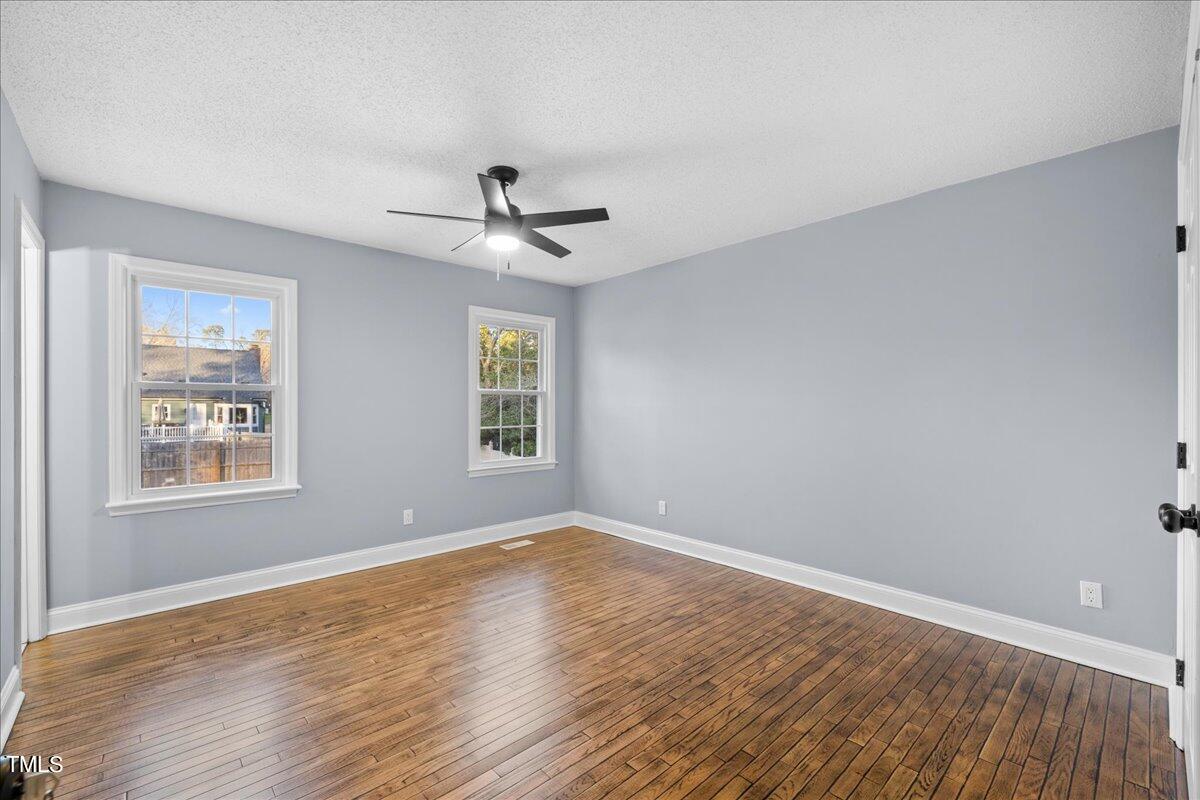 2025 Port Royal Road Raleigh, NC 27609 - Photo 33 of 67 a view of an empty room with a window and wooden floor