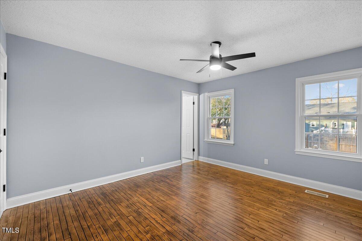 2025 Port Royal Road Raleigh, NC 27609 - Photo 35 of 67 a view of an empty room with a window and wooden floor