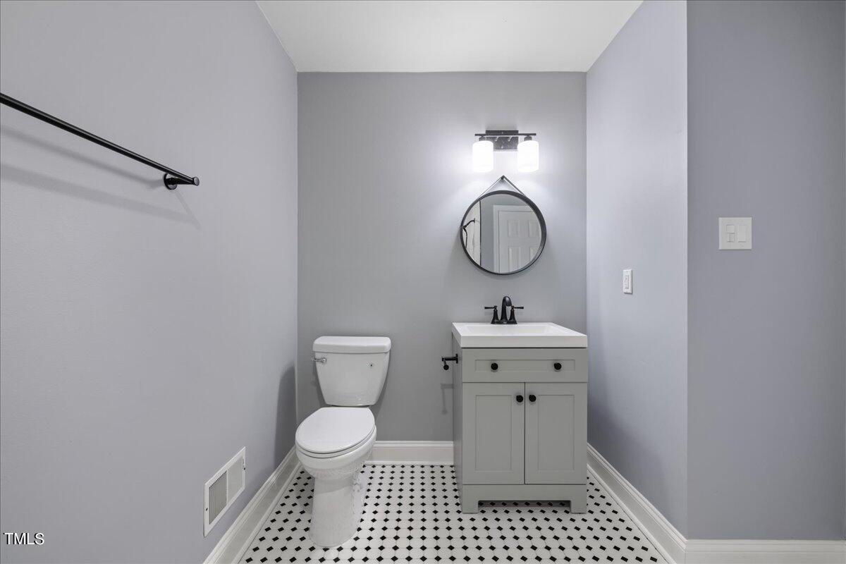 2025 Port Royal Road Raleigh, NC 27609 - Photo 44 of 67 a bathroom with a toilet a sink and a mirror