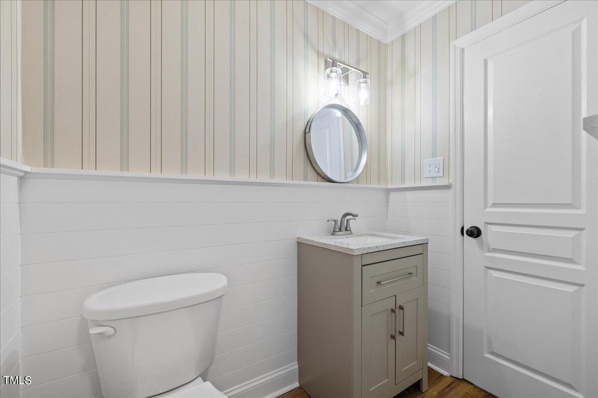 2025 Port Royal Road Raleigh, NC 27609 - Photo 51 of 67 a bathroom with a toilet a sink a vanity and mirror
