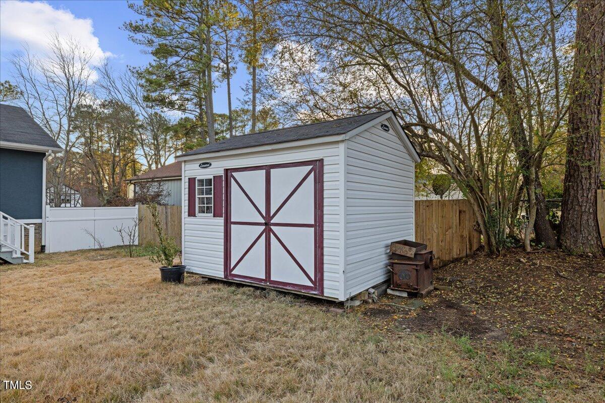 2025 Port Royal Road Raleigh, NC 27609 - Photo 60 of 67 a view of backyard with a barn and a large tree