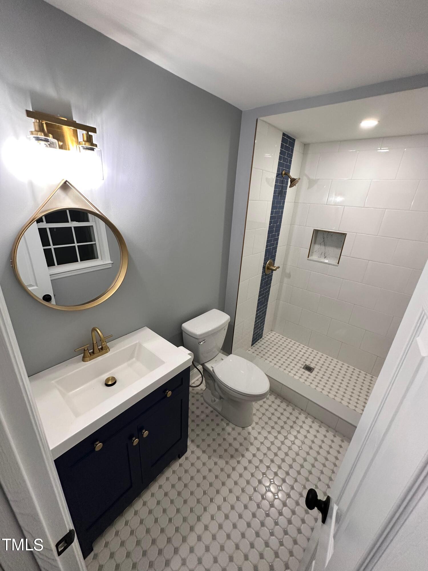 2025 Port Royal Road Raleigh, NC 27609 - Photo 6 of 67 a bathroom with a sink a toilet and mirror