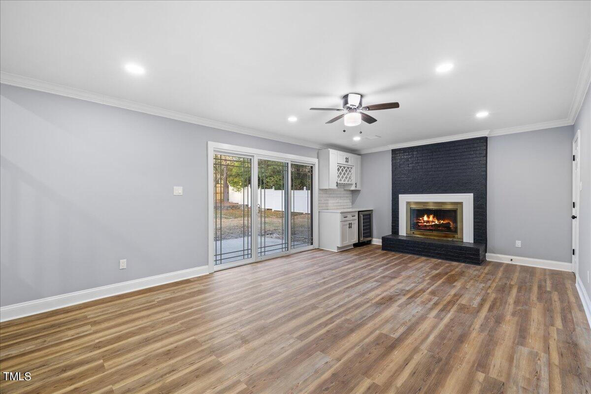 2025 Port Royal Road Raleigh, NC 27609 - Photo 8 of 67 a view of an empty room with a fireplace and a window