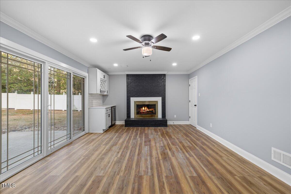 2025 Port Royal Road Raleigh, NC 27609 - Photo 9 of 67 wooden floor in an empty room with a fireplace