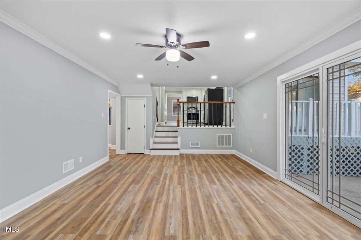2025 Port Royal Road Raleigh, NC 27609 - Photo 10 of 67 a view of empty room with wooden floor and ceiling fan
