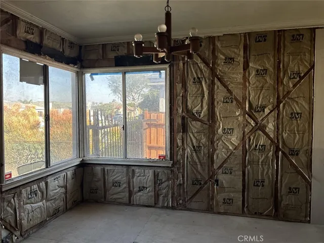 a view of a room with lots of windows and furniture