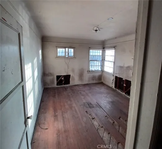 wooden floor in an empty room with a fireplace