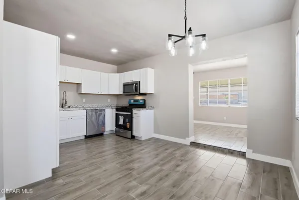 a kitchen with stainless steel appliances a refrigerator sink and microwave