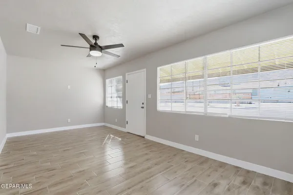 wooden floor in an empty room with a window
