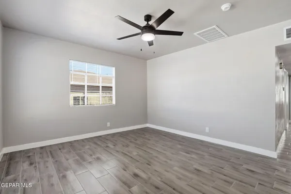 wooden floor in an empty room with a window