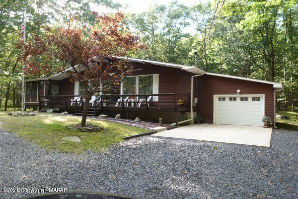 155 Chipmunk Road Bushkill, PA 18324 - Photo 1 of 18 a front view of a house with garden