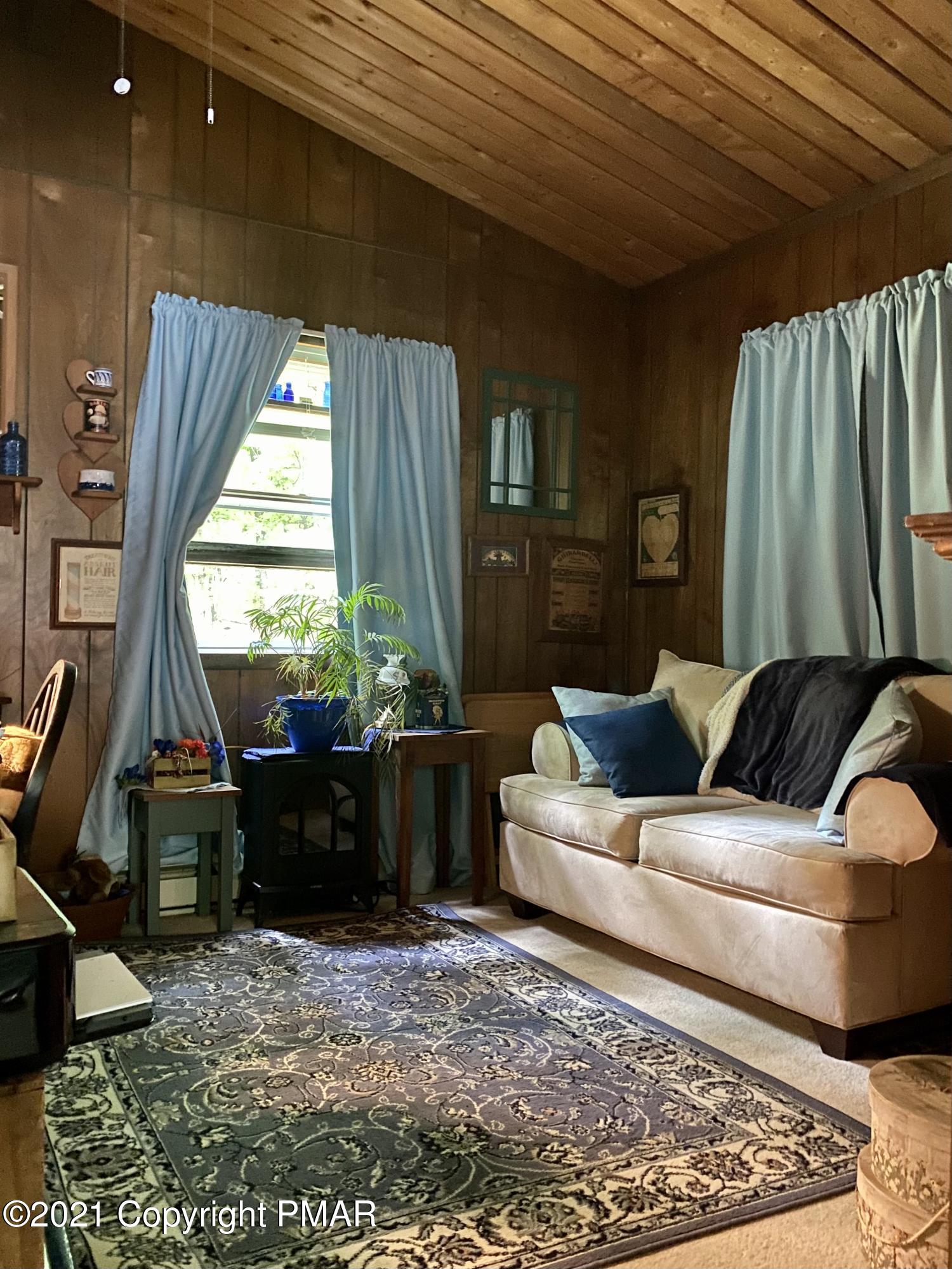 155 Chipmunk Road Bushkill, PA 18324 - Photo 11 of 18 a living room with furniture and a large window