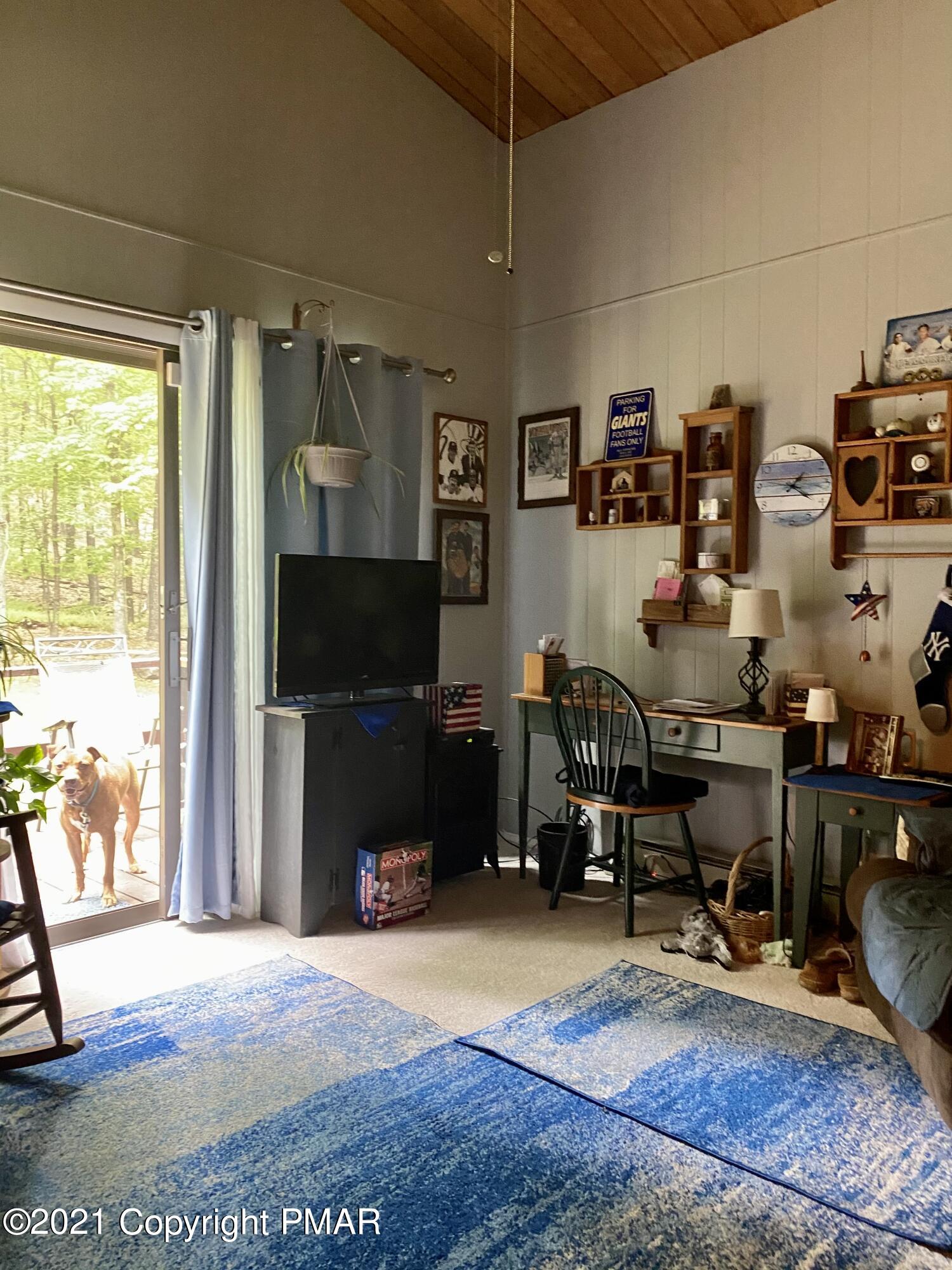 155 Chipmunk Road Bushkill, PA 18324 - Photo 15 of 18 a view of a livingroom with workspace and a window