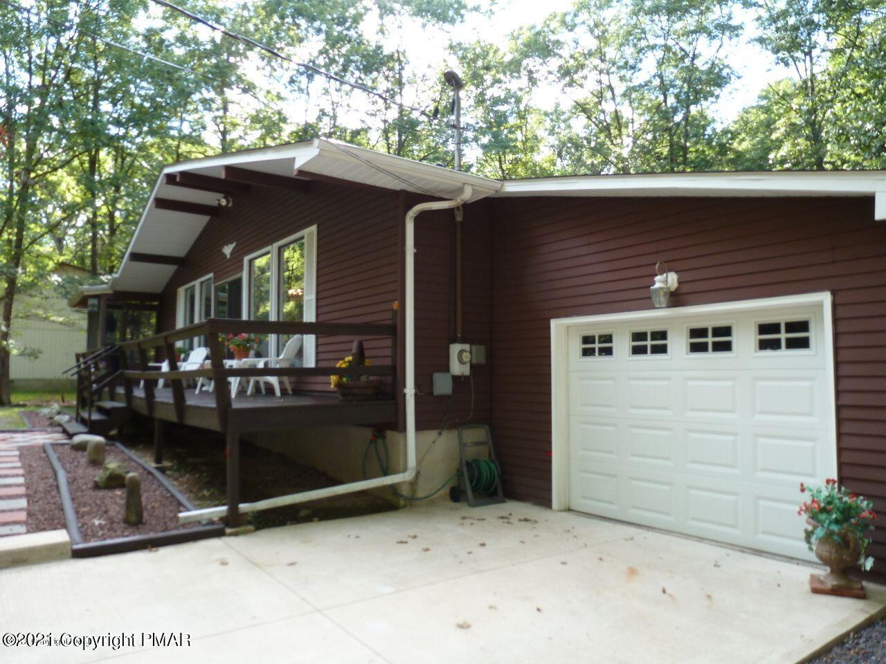 155 Chipmunk Road Bushkill, PA 18324 - Photo 3 of 18 a front view of a house with a garage