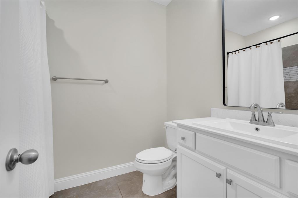 1601 Bear Path Way Gunter, TX 75058 - Photo 24 of 40 a bathroom with a toilet a sink and mirror