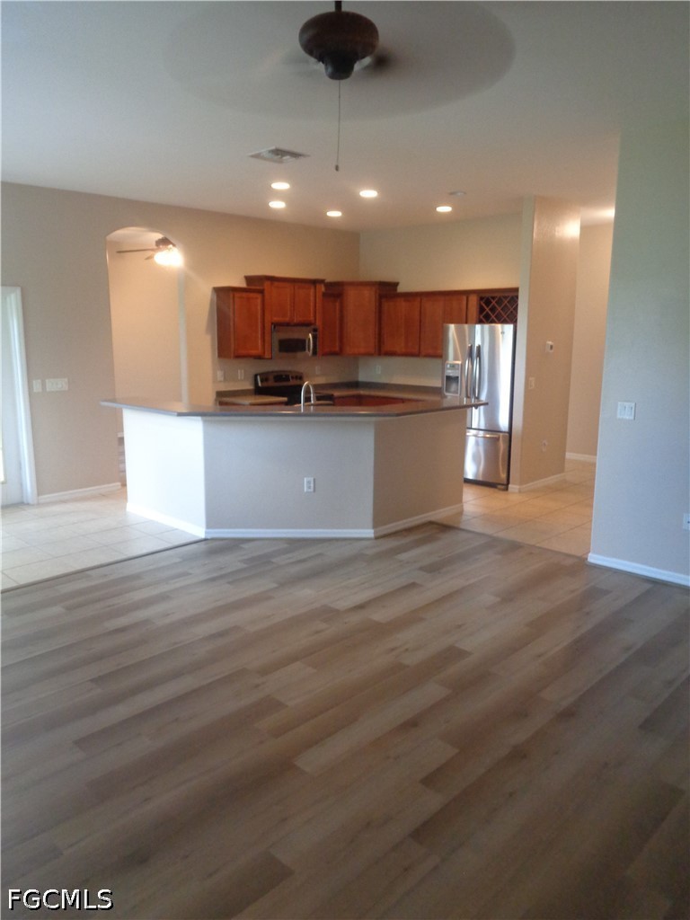 2463 Nature Pointe Loop Fort Myers, FL 33905 - Photo 11 of 50 a view of kitchen with stainless steel appliances wooden floor and large window