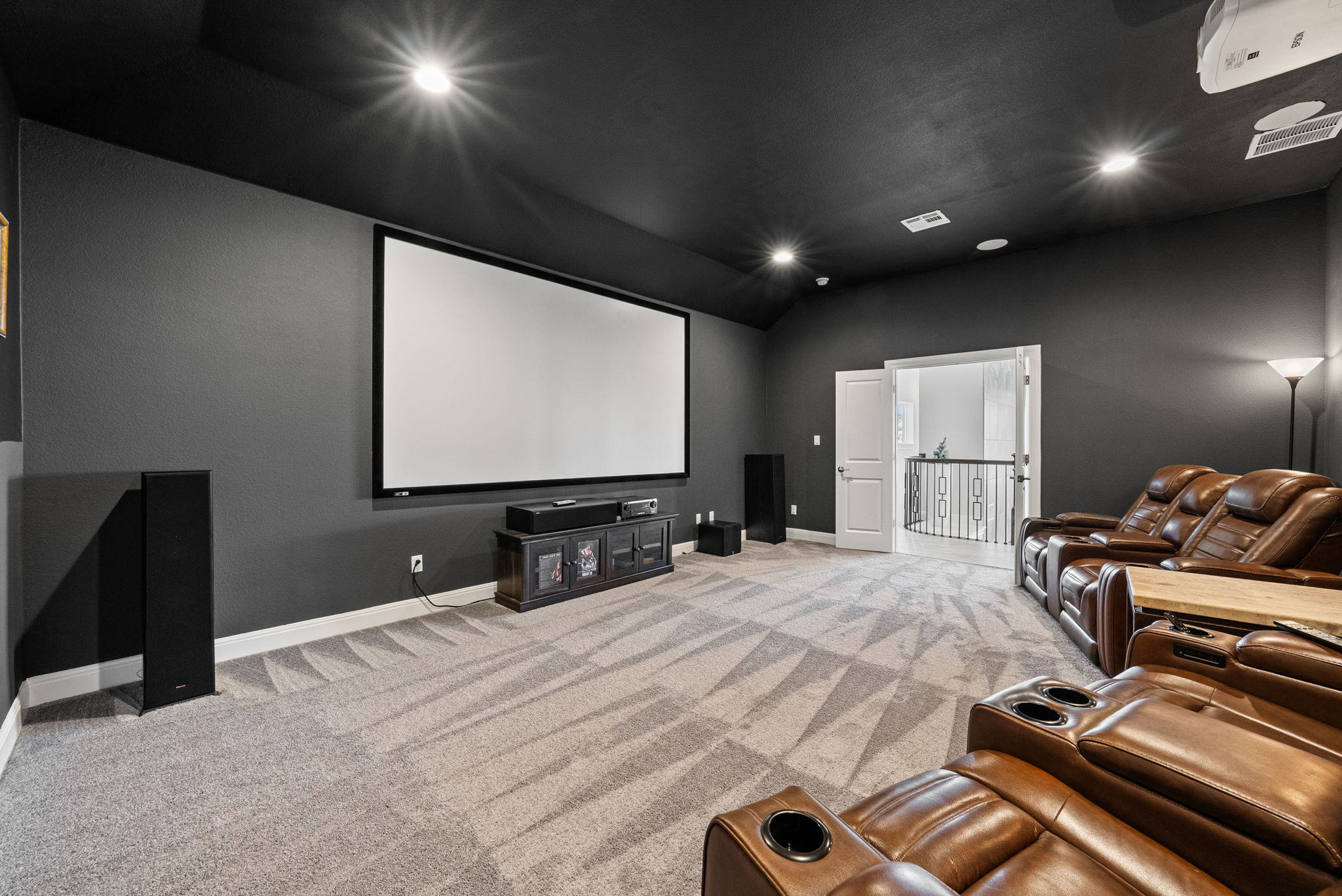 2132 Novara Trail Leander, TX 78641 - Photo 19 of 40 Home theater featuring recessed lighting, light colored carpet, and lofted ceiling