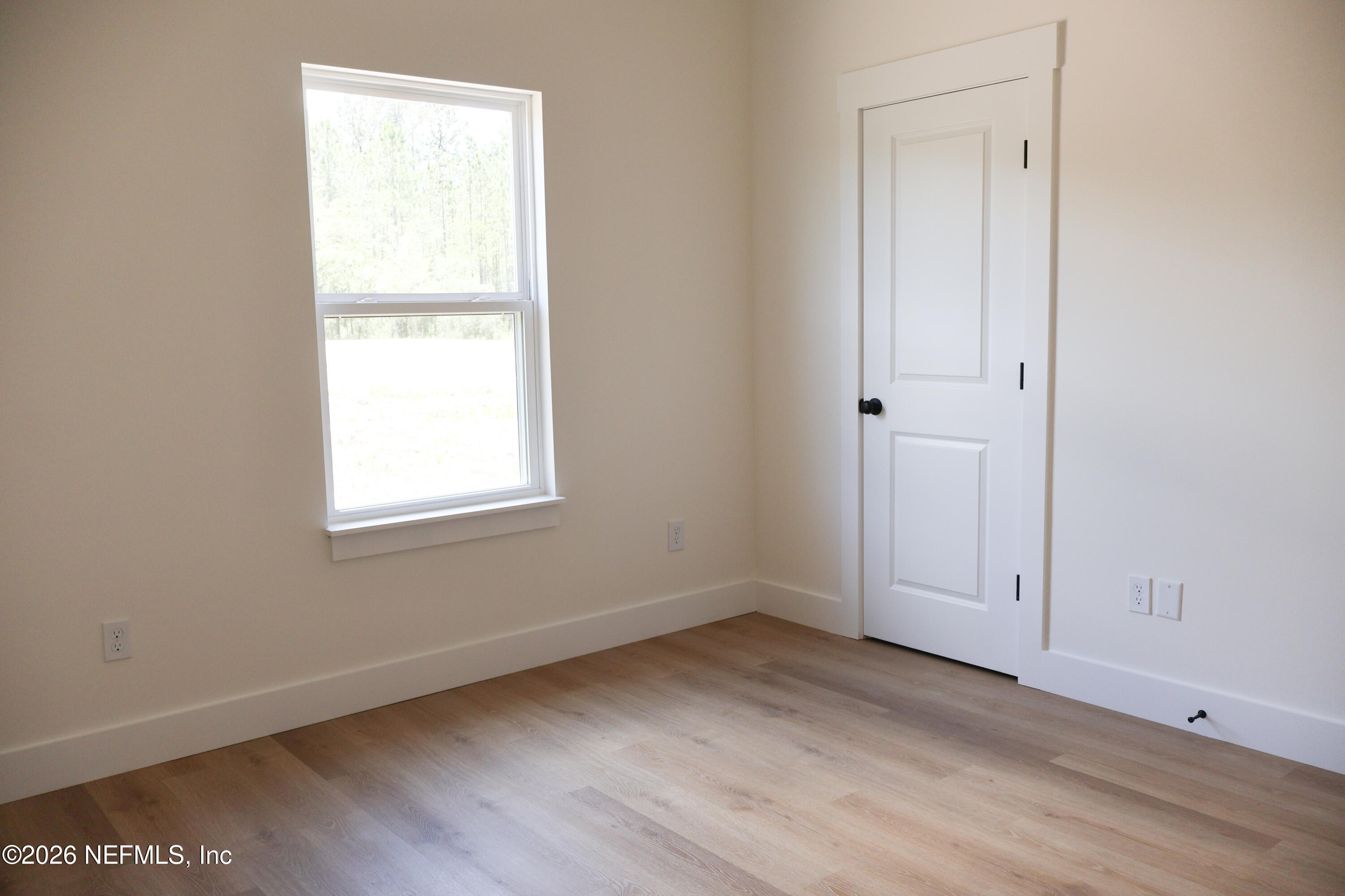 261121 Rowe Road Hilliard, FL 32046 - Photo 20 of 33 an empty room with wooden floor and closet