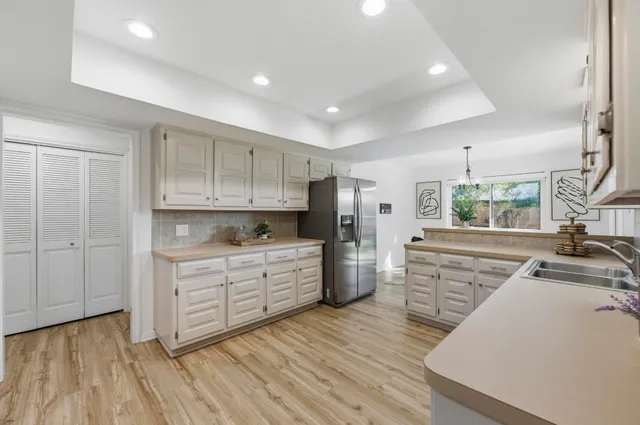 a kitchen with wooden floors and white appliances