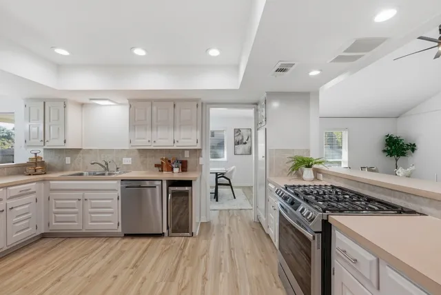 a kitchen with a sink stove and cabinets