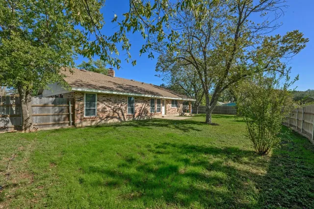 a view of a house with a backyard