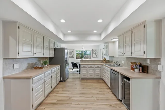 a kitchen with a sink stove and cabinets