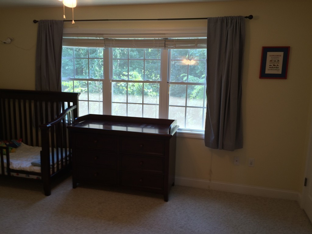 22 Whispering Pine Circle, Unit 29 Worcester, MA 01606 - Photo 16 of 30 a bed sitting in a bedroom next to a window