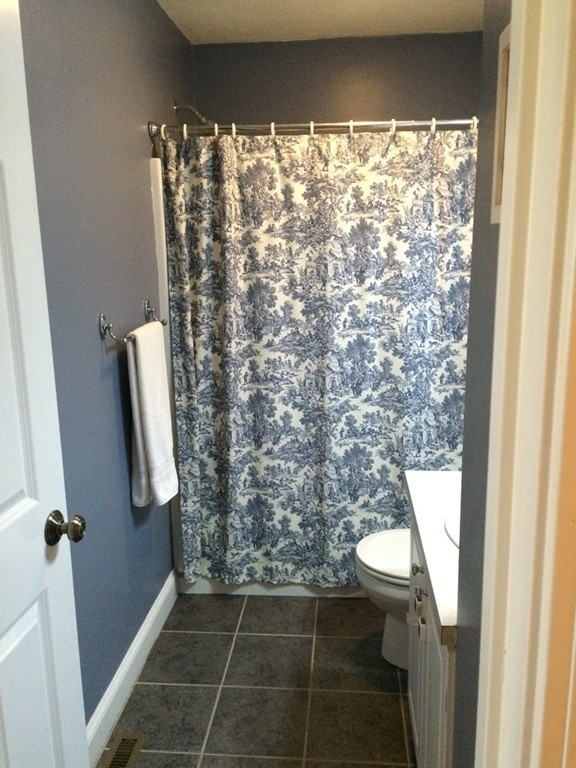 22 Whispering Pine Circle, Unit 29 Worcester, MA 01606 - Photo 19 of 30 a bathroom with a toilet and a shower curtain