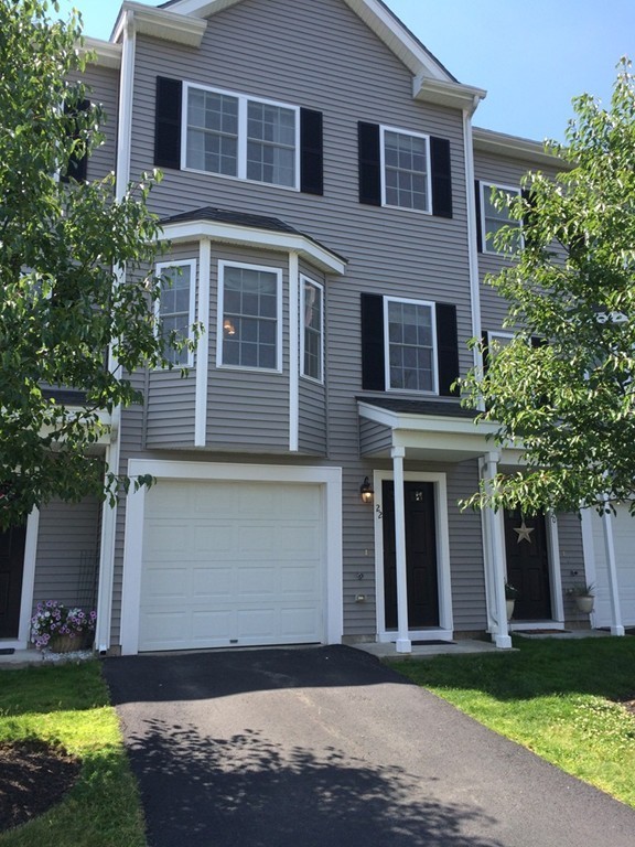 22 Whispering Pine Circle, Unit 29 Worcester, MA 01606 - Photo 2 of 30 a front view of a house with a yard and garage