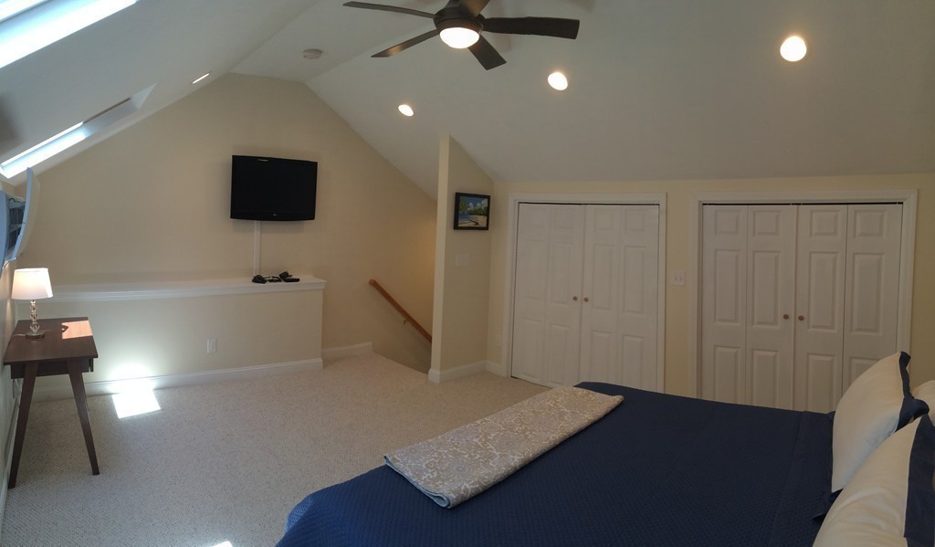 22 Whispering Pine Circle, Unit 29 Worcester, MA 01606 - Photo 22 of 30 a view of a livingroom with wooden floor and a ceiling fan