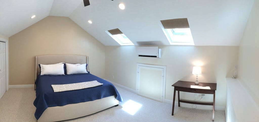 22 Whispering Pine Circle, Unit 29 Worcester, MA 01606 - Photo 23 of 30 a bedroom with a bed and a lamp